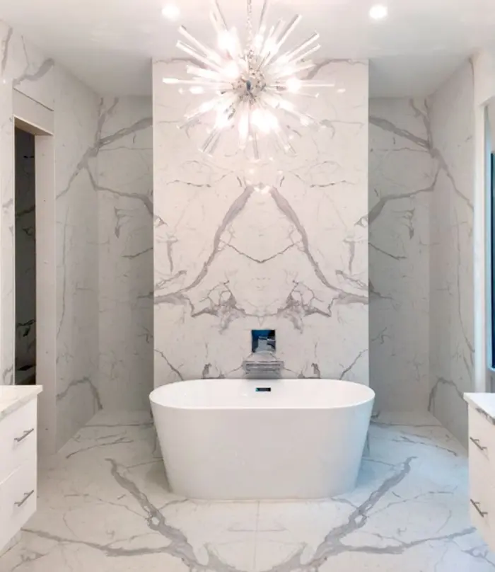 Bookmatched Statuario slab bathroom with freestanding bath