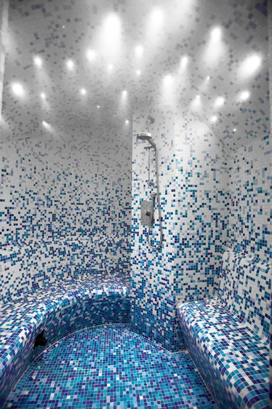 Steam room finished in a Eucalyptus shading blend of glass mosaic